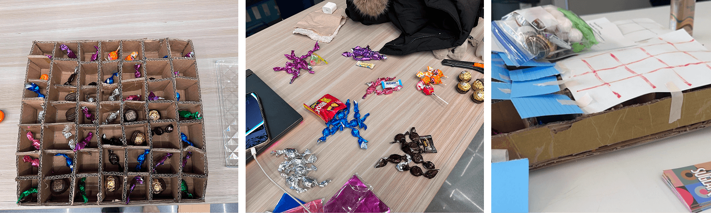 Cardboard grid prototype filled with wrapped candies, sorted candy on a table, and the taped play surface