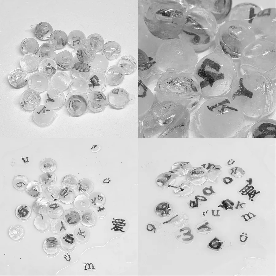 Ice beads with letters spelling out love cast inside them, shown whole and melting